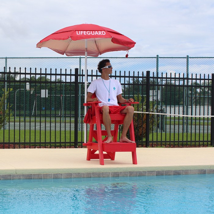 A lifeguard is sitting on a platform